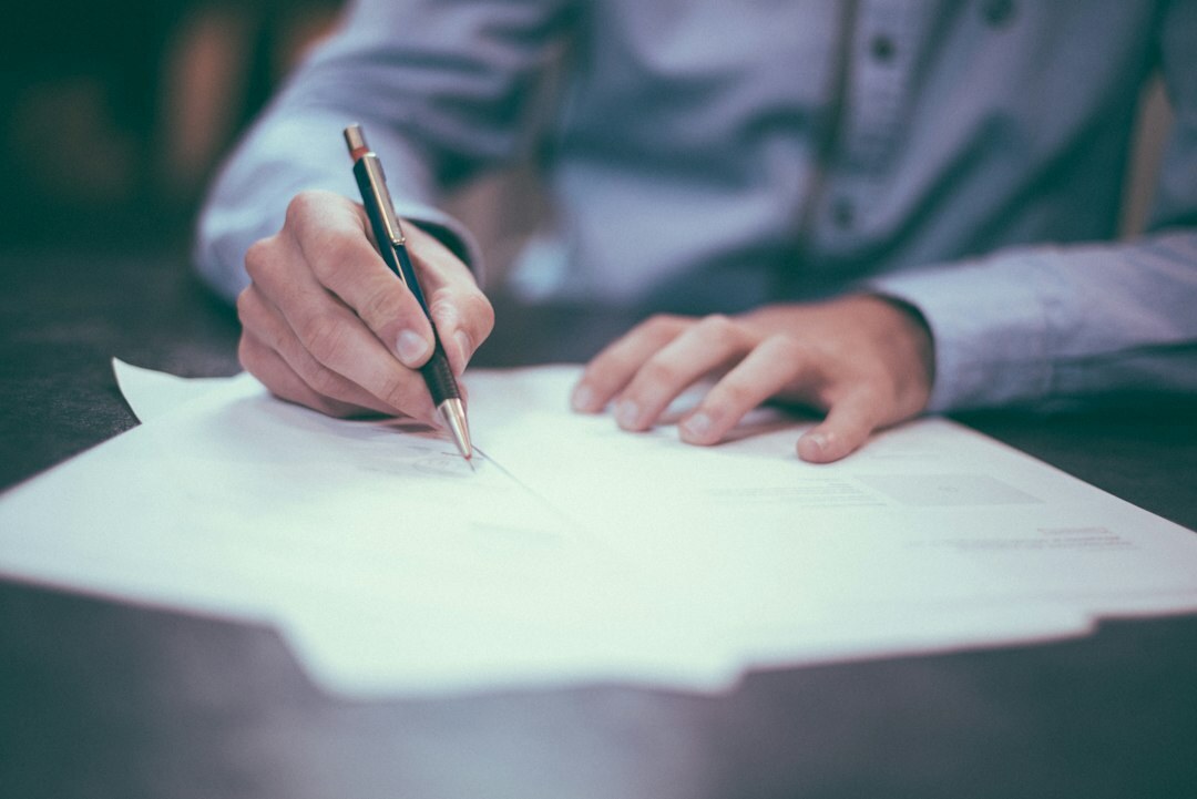 man writing notes